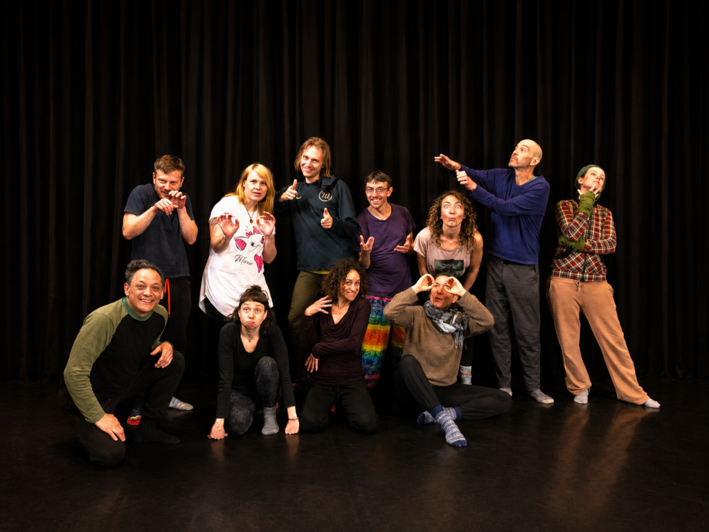 Physical theatre and improvisation training group in a performance studio